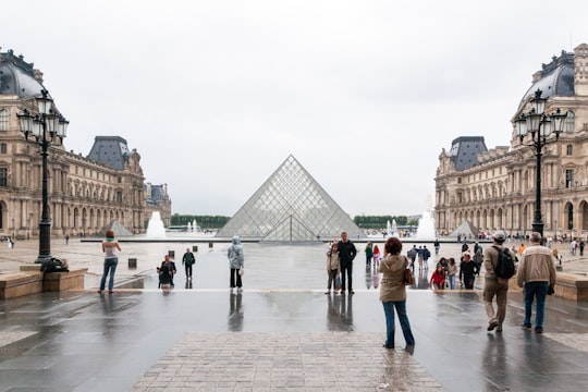 people walking on park during daytime in Louvre France