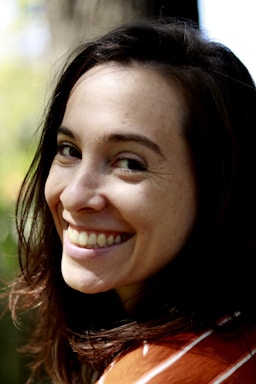A friendly dental receptionist smiling warmly at the front desk of Kaur Smiles Dental Corp.