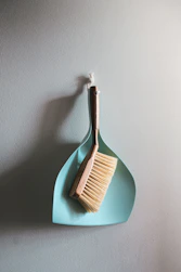 Spring home maintenance checklist for NJ homeowners — dustpan and brush ready for seasonal cleaning
