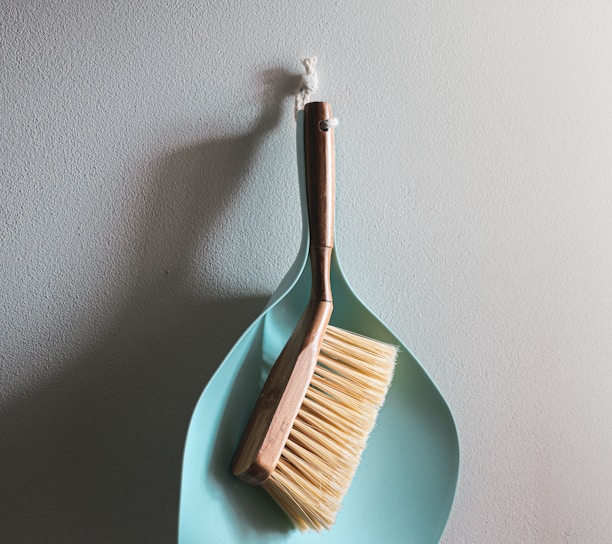 brown wooden brush on white wall