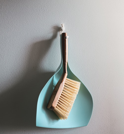 brown wooden brush on white wall