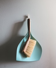 brown wooden brush on white wall