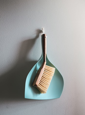 brown wooden brush on white wall