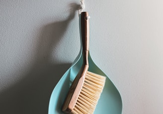 brown wooden brush on white wall