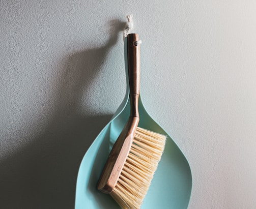 brown wooden brush on white wall