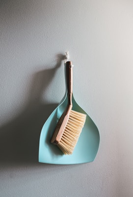 brown wooden brush on white wall