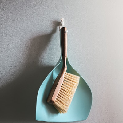 brown wooden brush on white wall