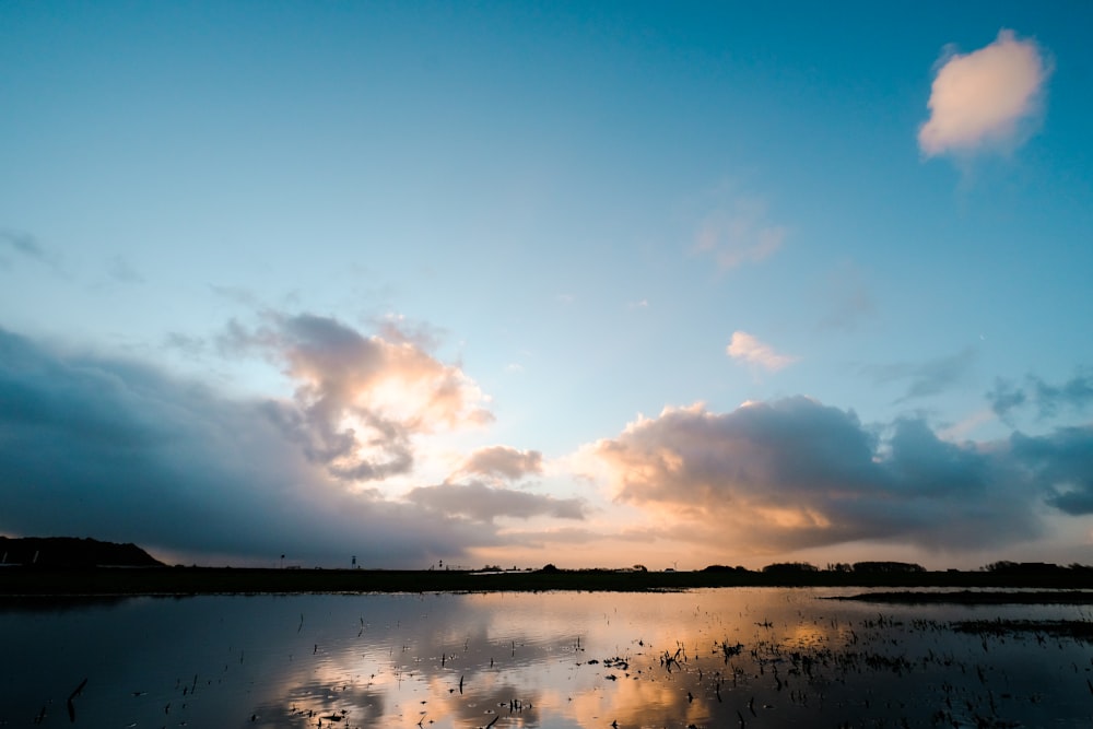 body of water under blue sky during daytime