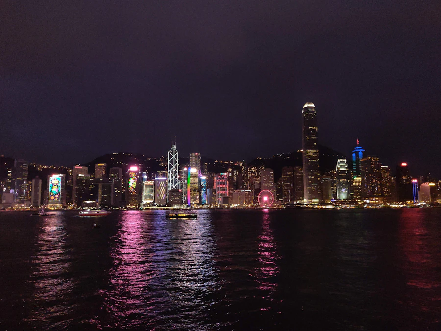 Wine glasses against Victoria Harbour skyline at night