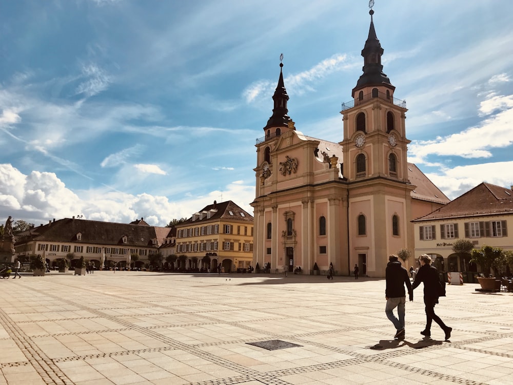 people walking near brown concrete building during daytime