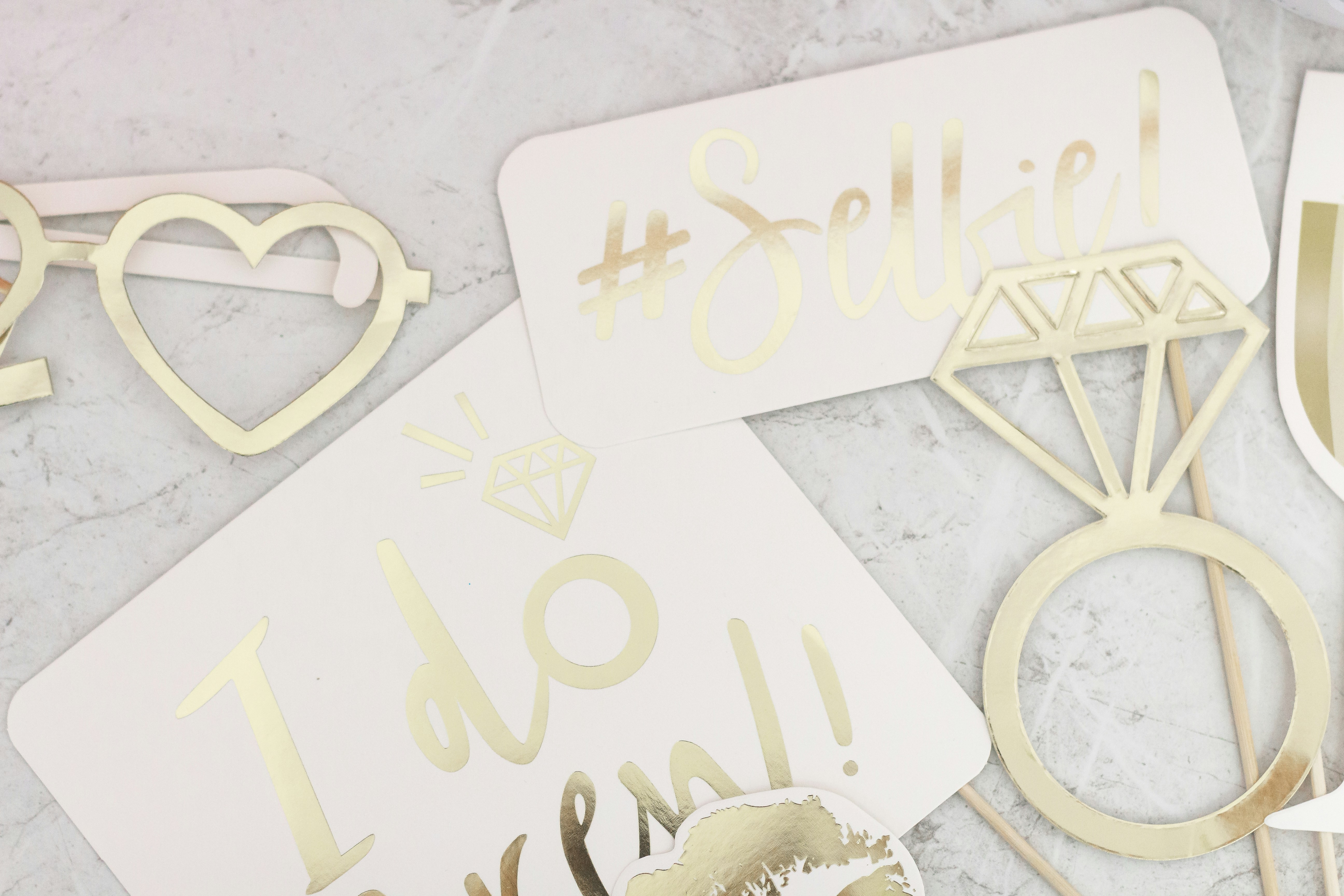 Photo booth props arranged on a marble surface.