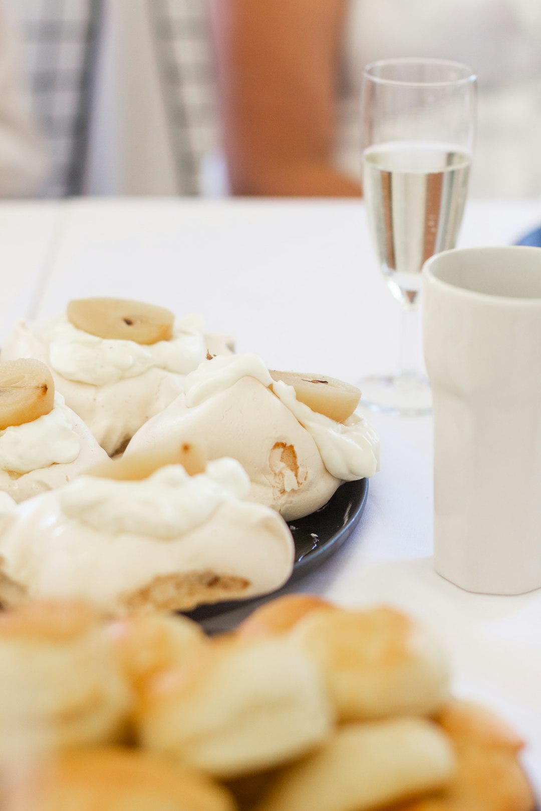 white ceramic mug beside white ceramic plate with cookies
