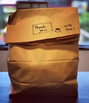 brown paper bag on brown wooden table