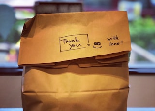 brown paper bag on brown wooden table