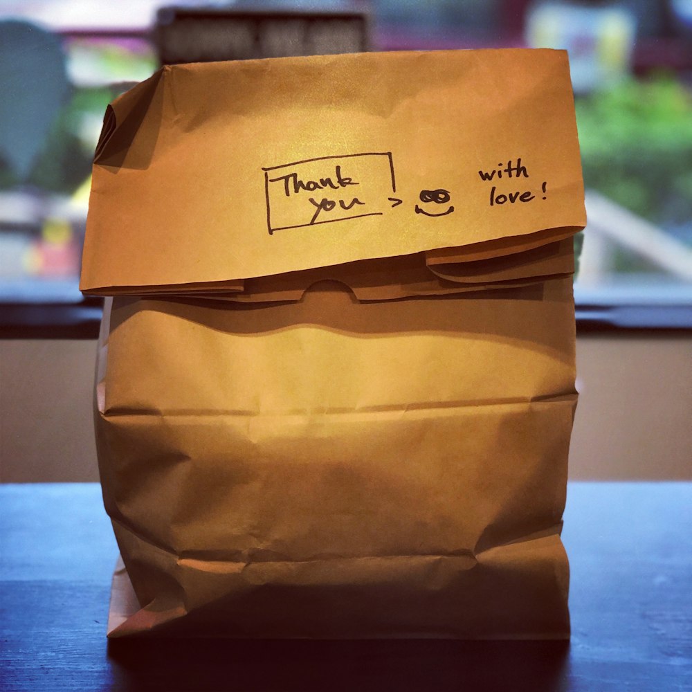 brown paper bag on brown wooden table