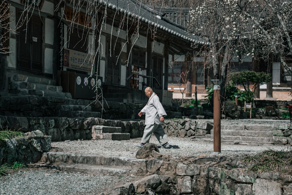 man in white dress shirt sitting on gray concrete bench during daytime