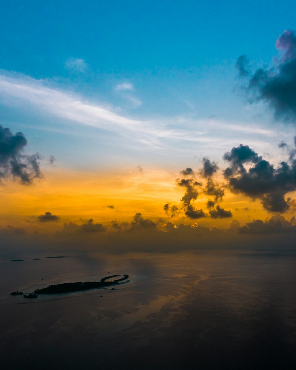 white boat on sea under blue sky during sunset