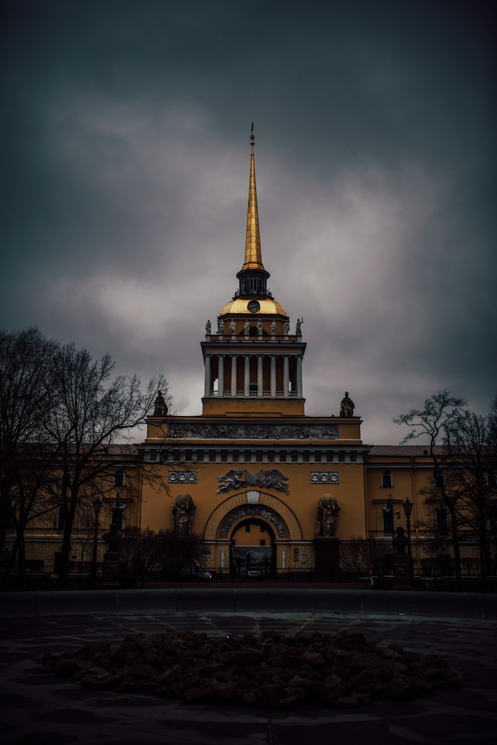 brown concrete building under gray clouds