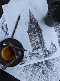 black ceramic mug with brown liquid on white and black table