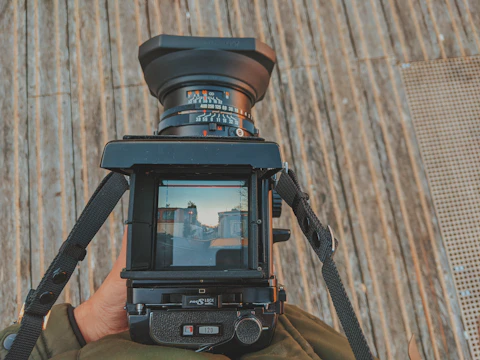 A documentary filmmaker capturing a historic landmark with a vintage camera.