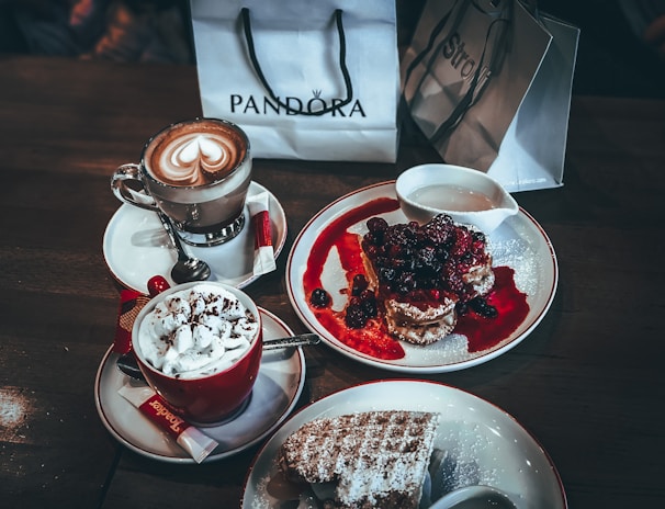 A cozy café scene with customers enjoying mocktails and waffles.