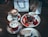 A cozy café interior with families enjoying waffles together.