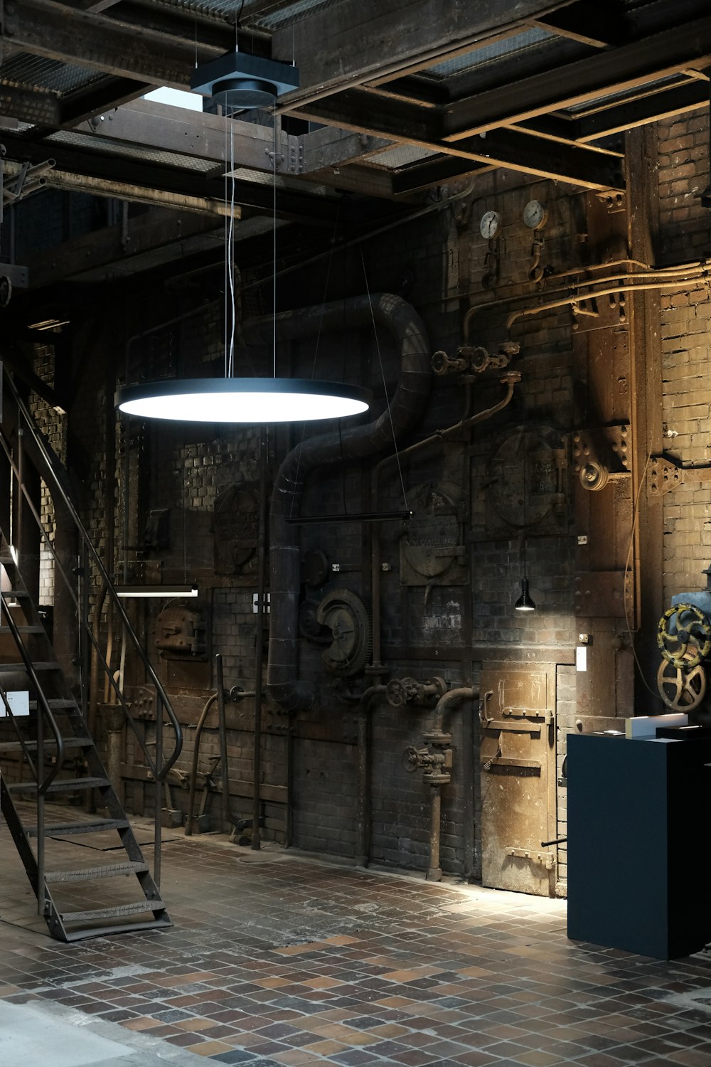 black pendant lamp turned on near brown wooden wall