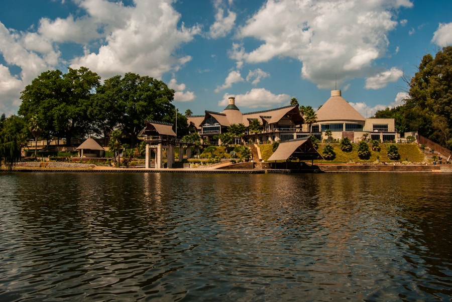 Lakefront estate seen from the water with terraced landscaping and a private dock