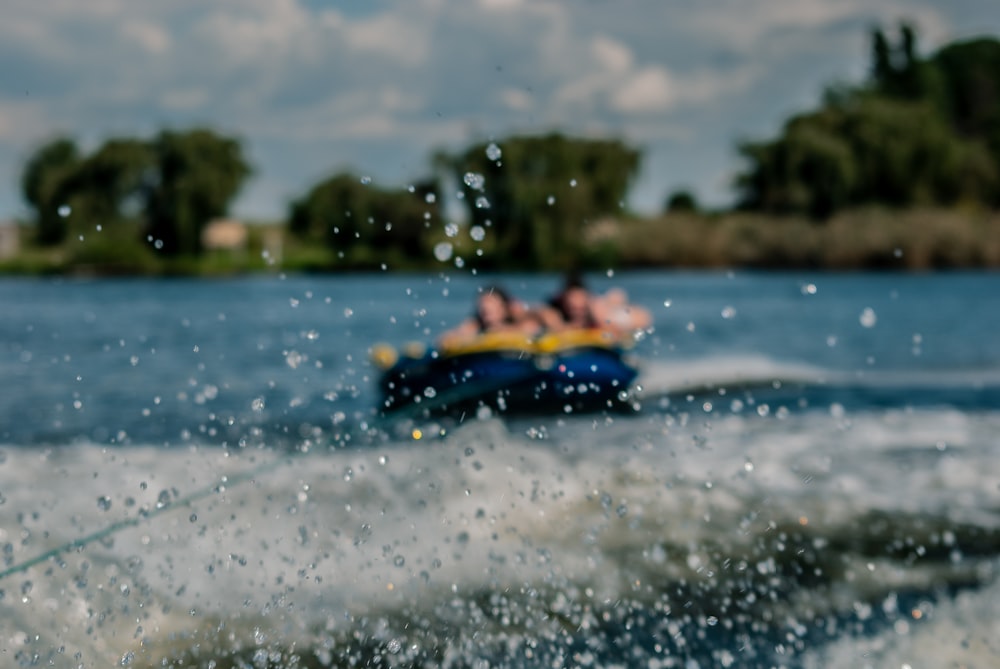 people riding yellow kayak on sea during daytime