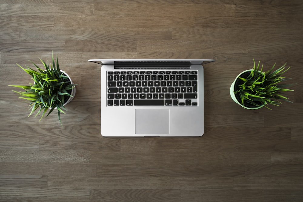 macbook pro on brown wooden table