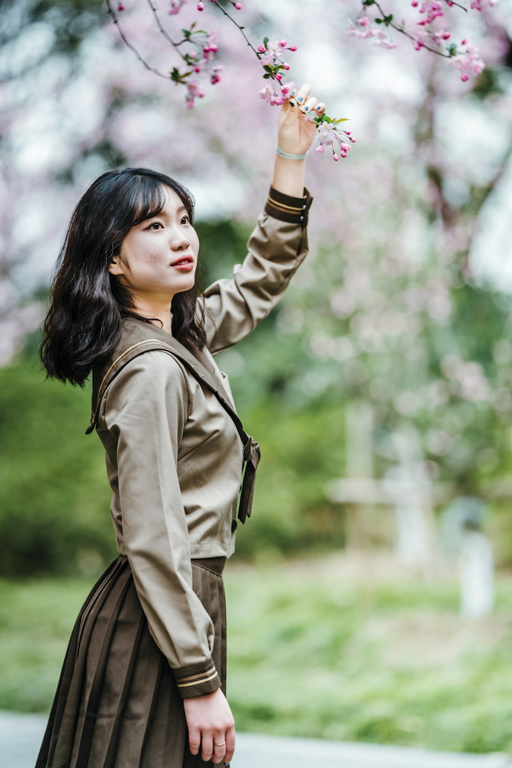 woman in brown coat standing and smiling