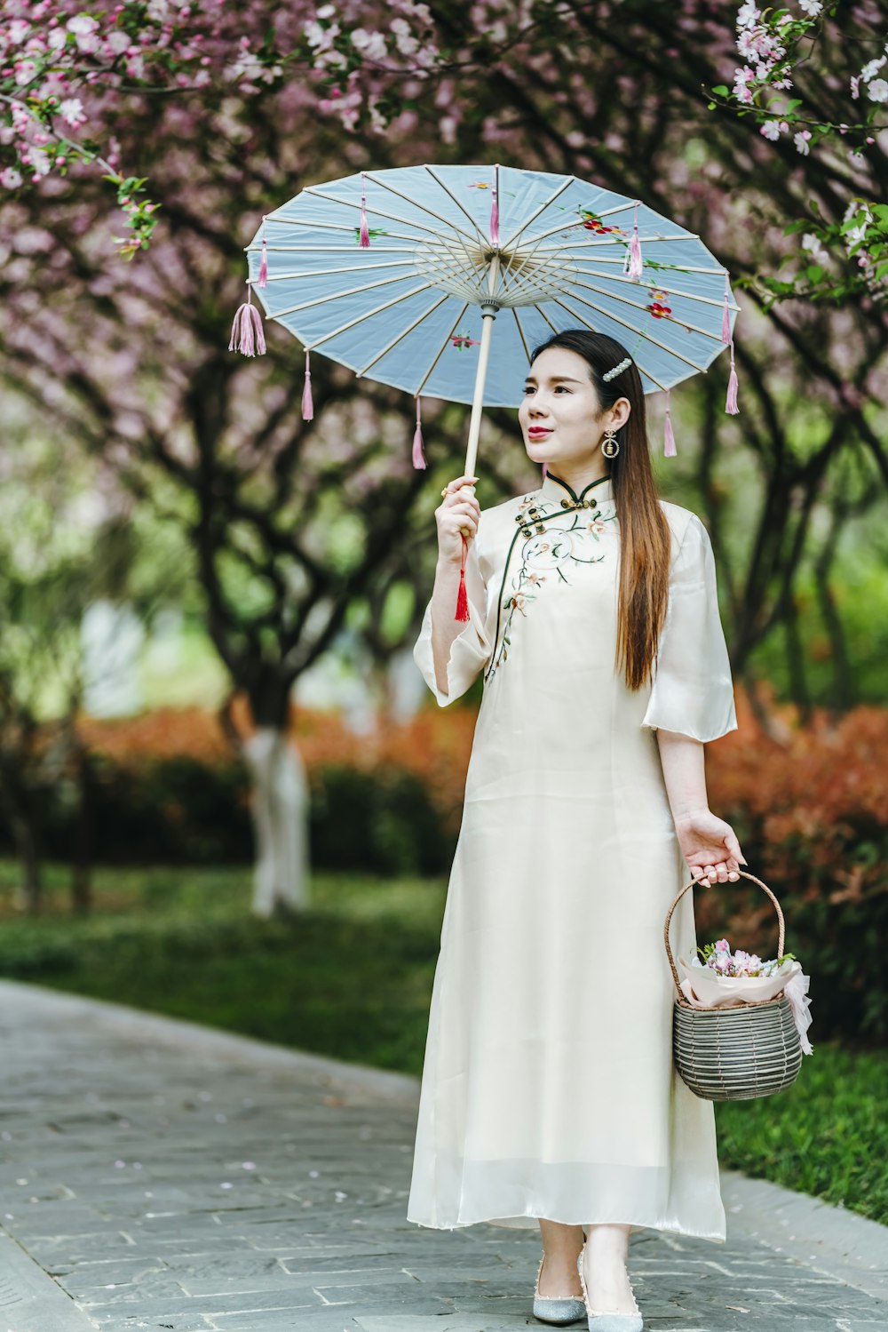 woman in white dress holding umbrella