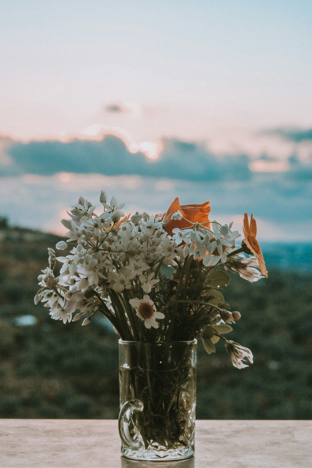 white flowers in clear glass vase