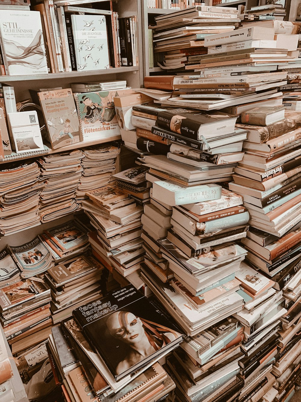 stack of books on brown wooden table