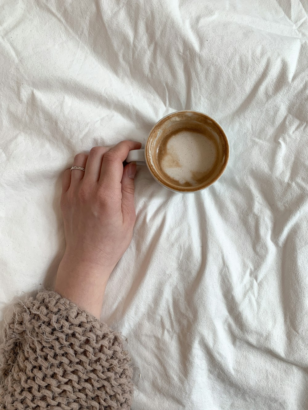 person holding white ceramic mug