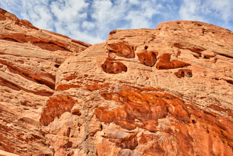 brown rock formation under blue sky and white clouds during daytime