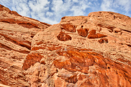 brown rock formation under blue sky and white clouds during daytime