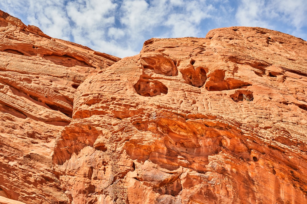 brown rock formation under blue sky and white clouds during daytime