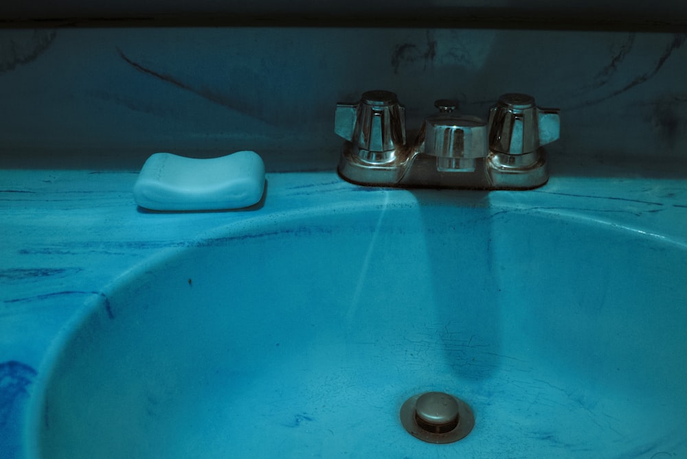 stainless steel condiment shakers on blue ceramic sink