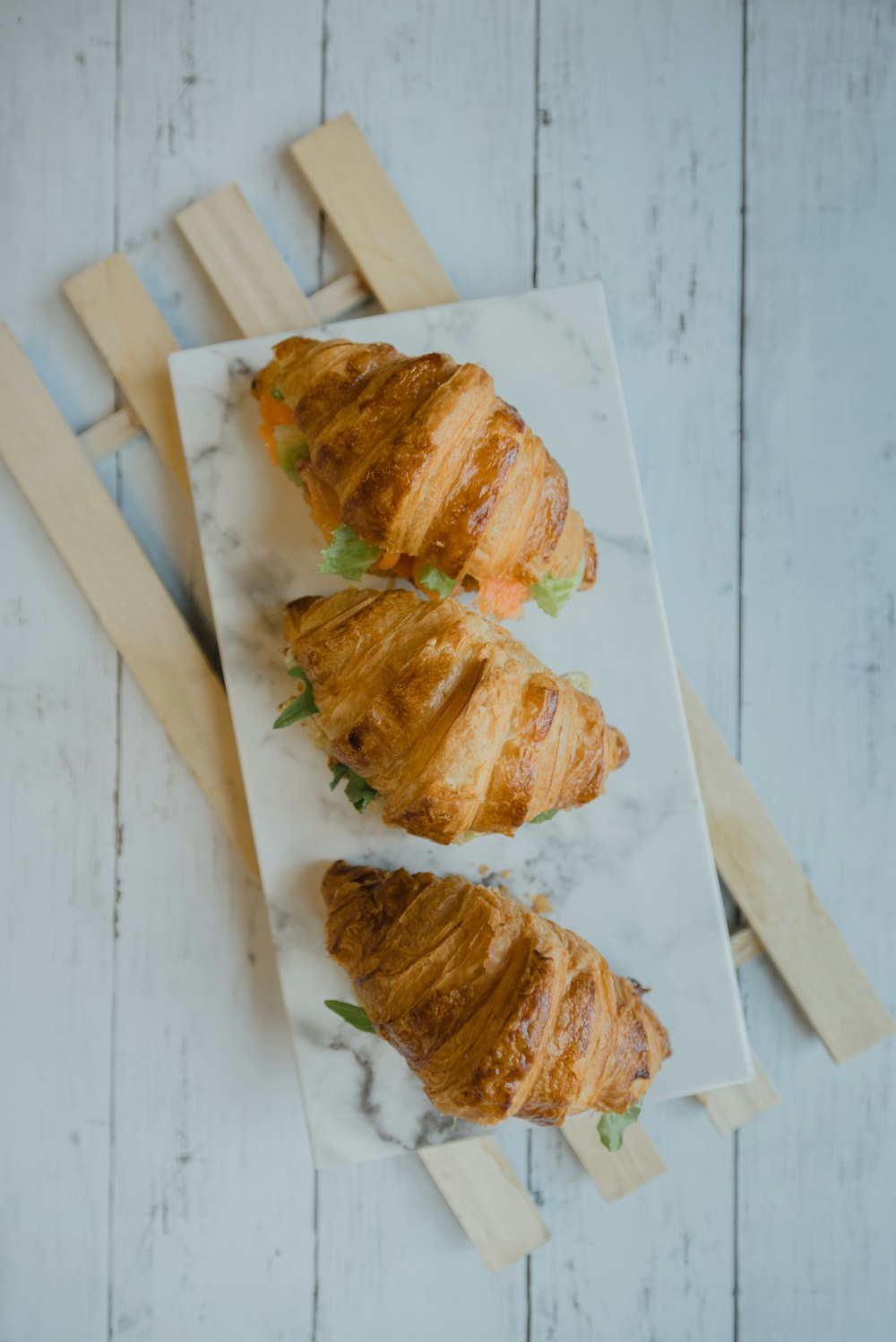 sliced bread on white wooden chopping board