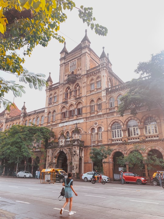 cars parked in front of brown concrete building during daytime in Chhatrapati Shivaji Maharaj Vastu Sangrahalaya India