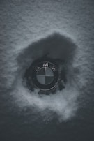 A minimalist logo of 'elseason' with a delicate snowflake icon glowing softly on a cool gray background.