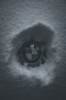 A minimalist logo of 'elseason' with a delicate snowflake icon glowing softly on a cool gray background.