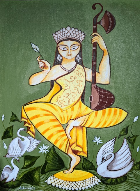A stylized painting of a figure holding a musical instrument in one hand and a leaf in the other, with an elaborate headdress. The figure is dressed in a yellow garment with ornate patterns and stands on one leg atop a lotus flower. Swans and green foliage surround the figure, adding to the serene and artistic composition.
