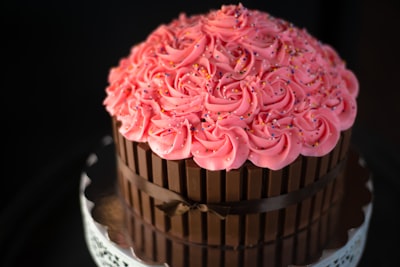 pink cupcake on white ceramic plate dessert teams background