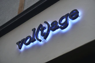 A glowing volt logo illuminated on a dark wall, symbolizing protection.