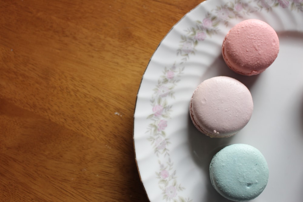 pink blue and green macaroons on white ceramic plate