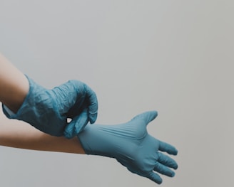 hands with blue medical gloves