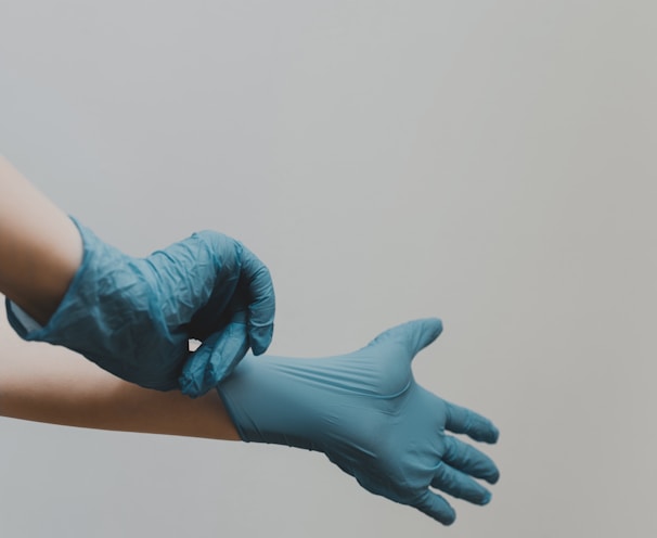 hands with blue medical gloves