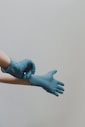 une personne avec une paire de gants bleus